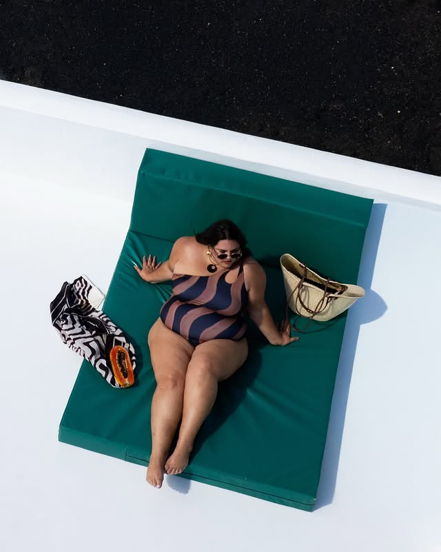 Instagram post by @calliethorpe for Monsoon. Caption reads: The Callie X Monsoon one-shoulder wavy swim. | AD....
