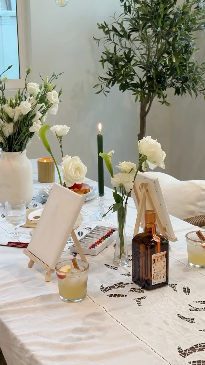 Instagram post by @kristincabat for Cointreau. Caption reads: hosting a cozy paint & sip brunch to celebrate the....