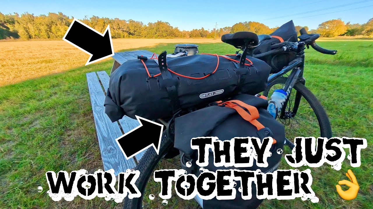 YouTube post by @ClintGibbs for OutdoorMaster. Caption reads: Ortlieb Dry Pack + Quick Rack + Thru Axle – The....