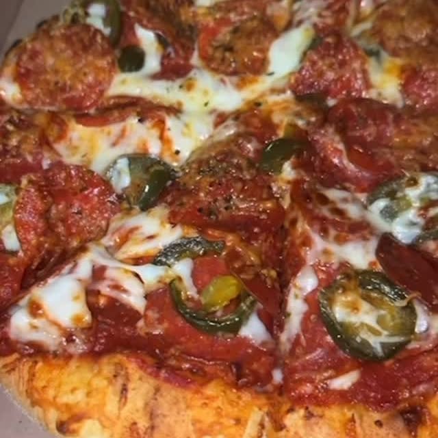 Instagram post by @kalesefoodie for Domino's. Caption reads: #ad Hard launch 🍕@dominos....