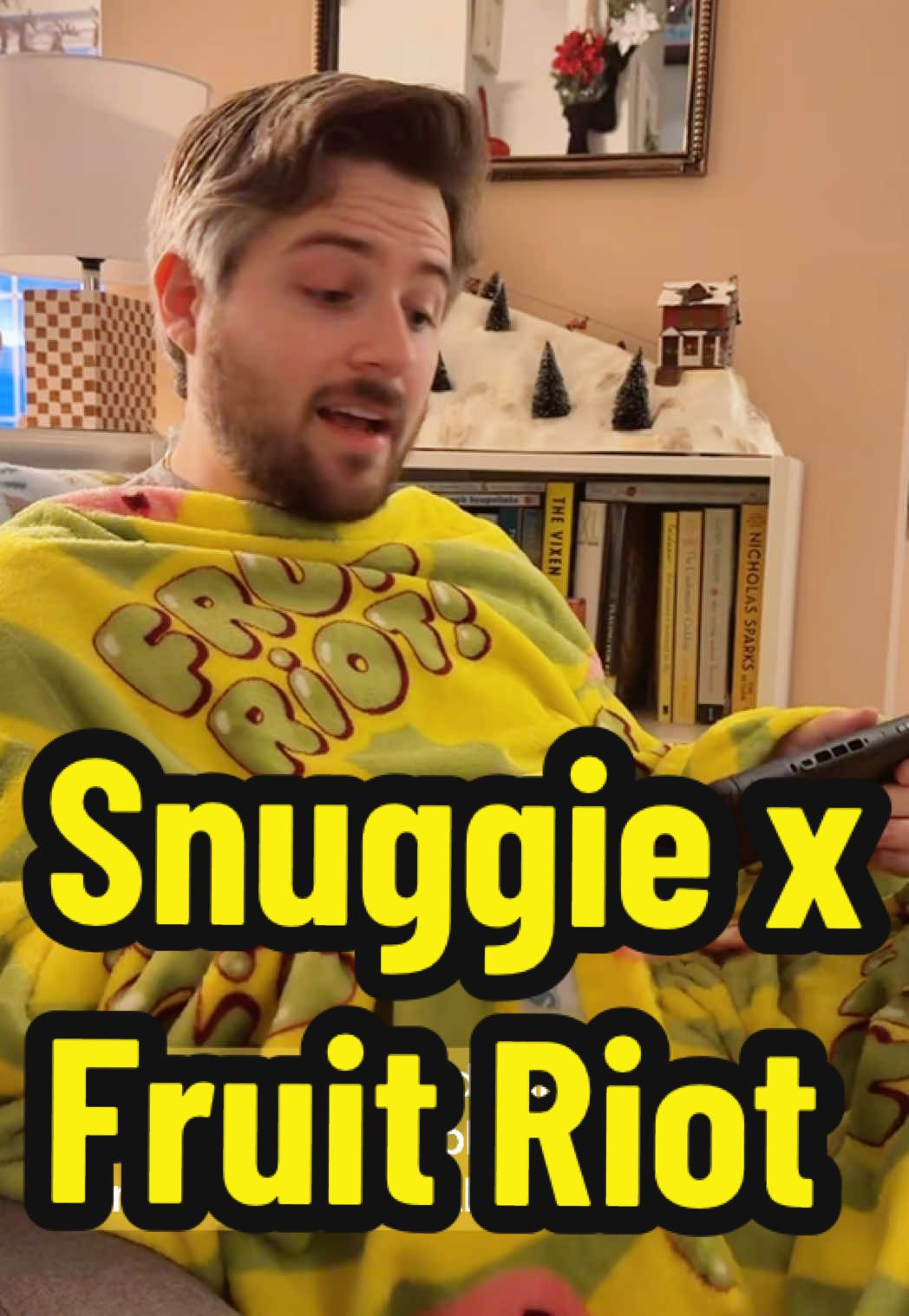 TikTok post by @doonbugsttv for Snuggie. Caption reads: Thanks @Snuggie for this super cozy @fruit riot....