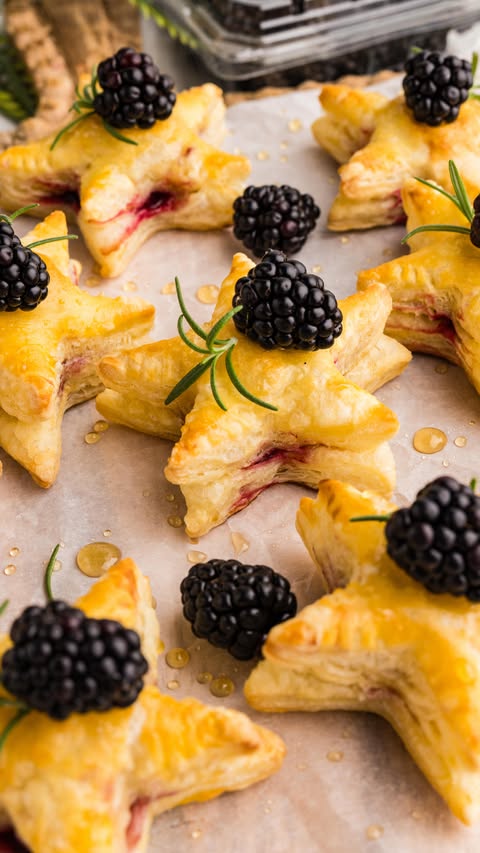Instagram post by @anniekaly for The Feedfeed. Caption reads: (ad) These Blackberry Puff Pastry Stars with....