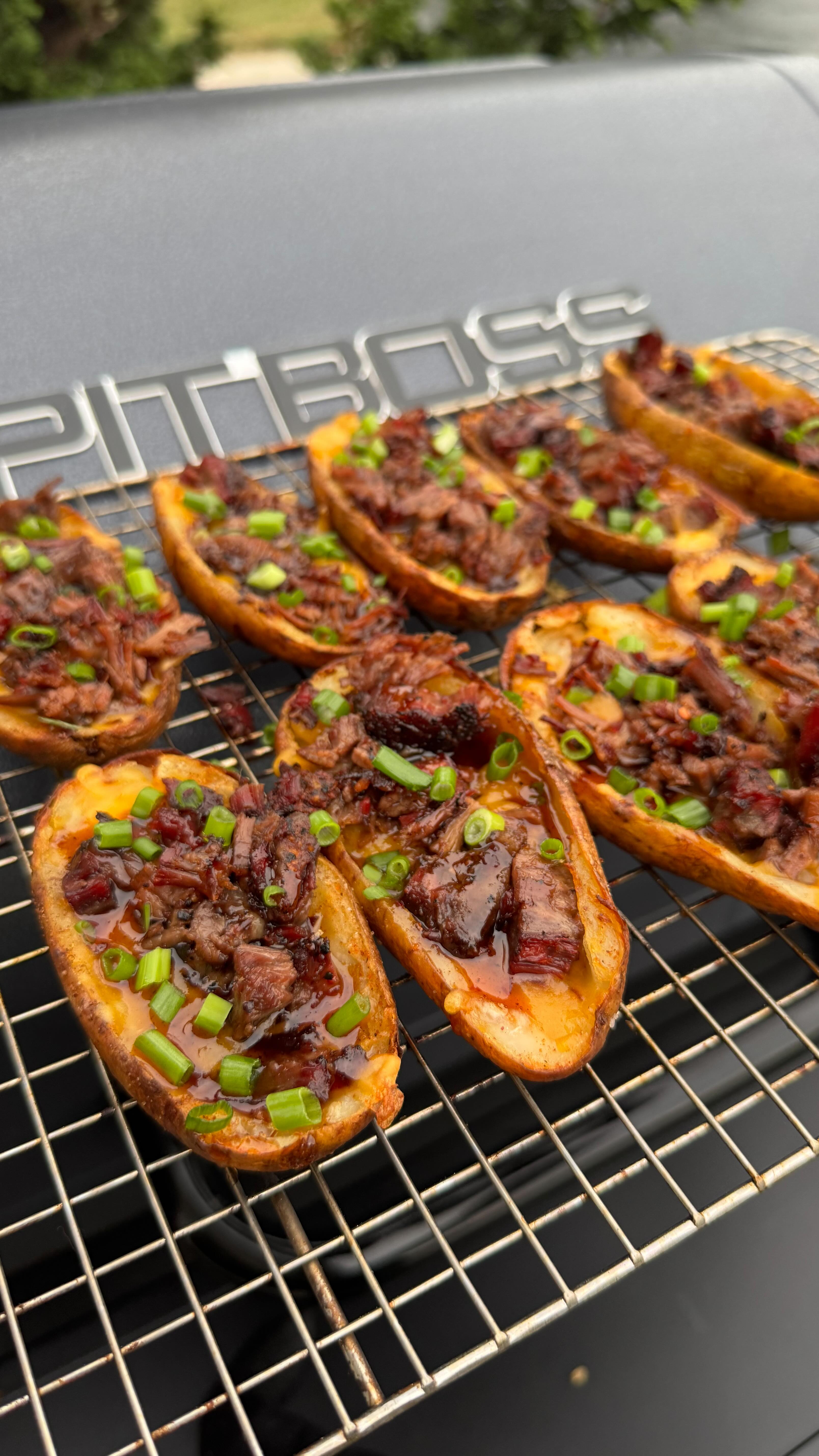 Instagram post by @patriotic_bbq for Pit Boss Grills. Caption reads: Let’s cook Loaded Brisket Potato Skins on the....