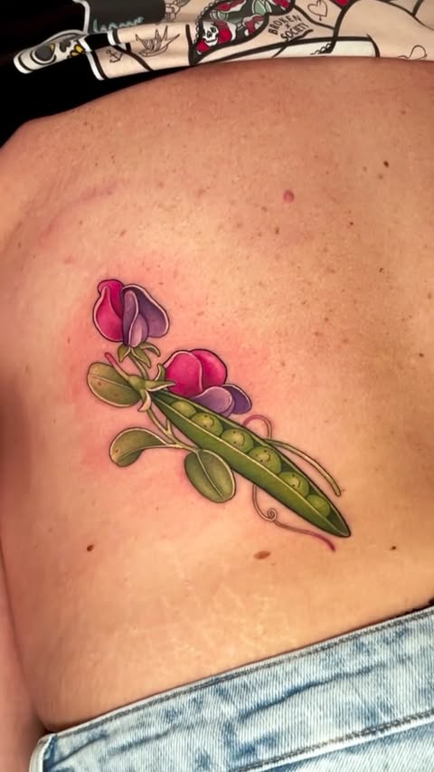 Instagram post by @hattiejcox_tattoo for Butterluxe Tattoo Care. Caption reads: the sweetest lower back pea pals for Linda 🫛🩷....