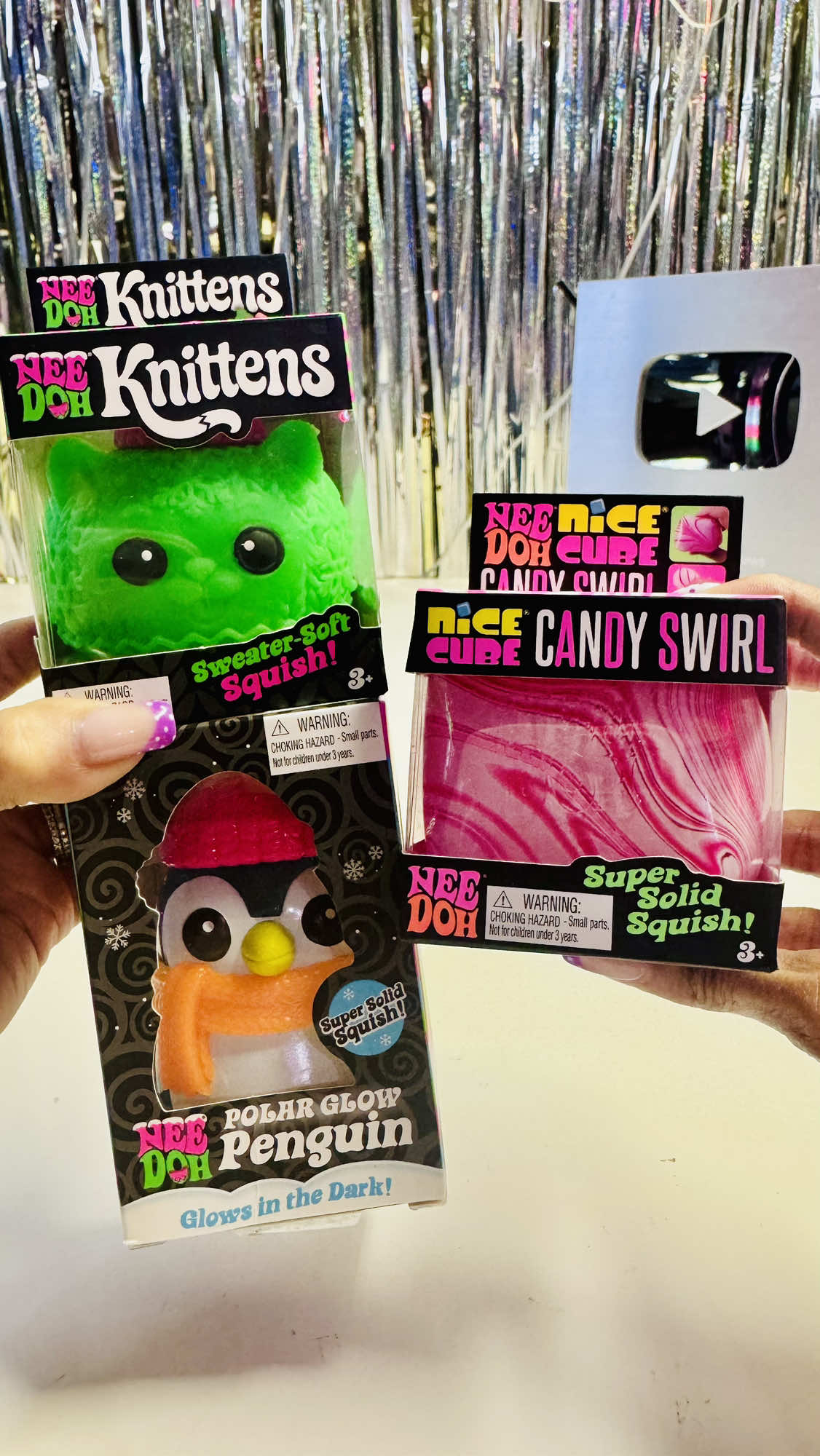TikTok post by @momandmorereviews for NeeDoh (Schylling). Caption reads: NEW🎄✨Holiday NEEDOHS!🎁 👀🫣Get your SNEAK PEEK....