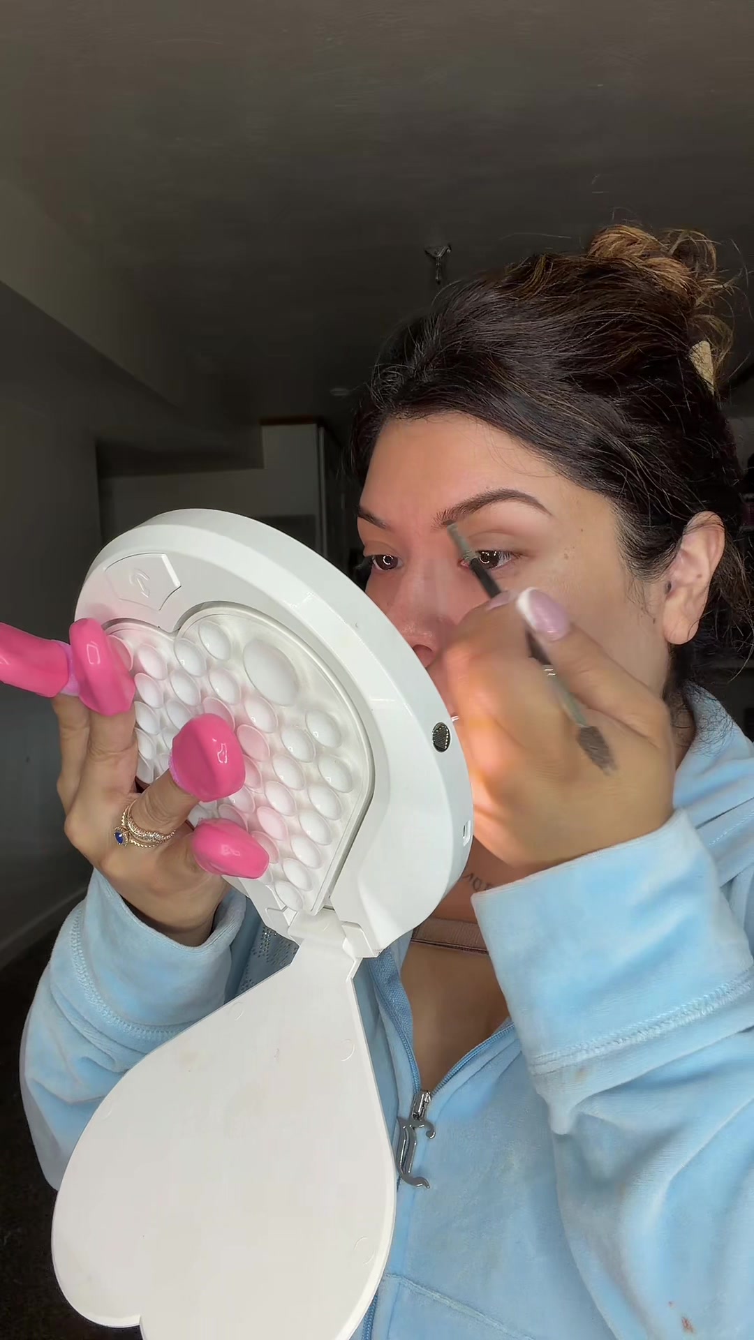 TikTok post by @lizzieliz619 for RIKI LOVES RIKI. Caption reads: [...] to do my eyebrows it’s so bright....