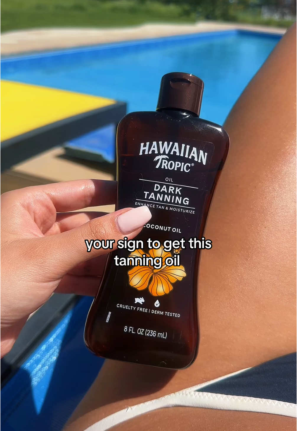 TikTok post by @avarygg for Hawaiian Tropic. Caption reads: [...] this oil is AMAZINGGGGGG @Hawaiian Tropic....