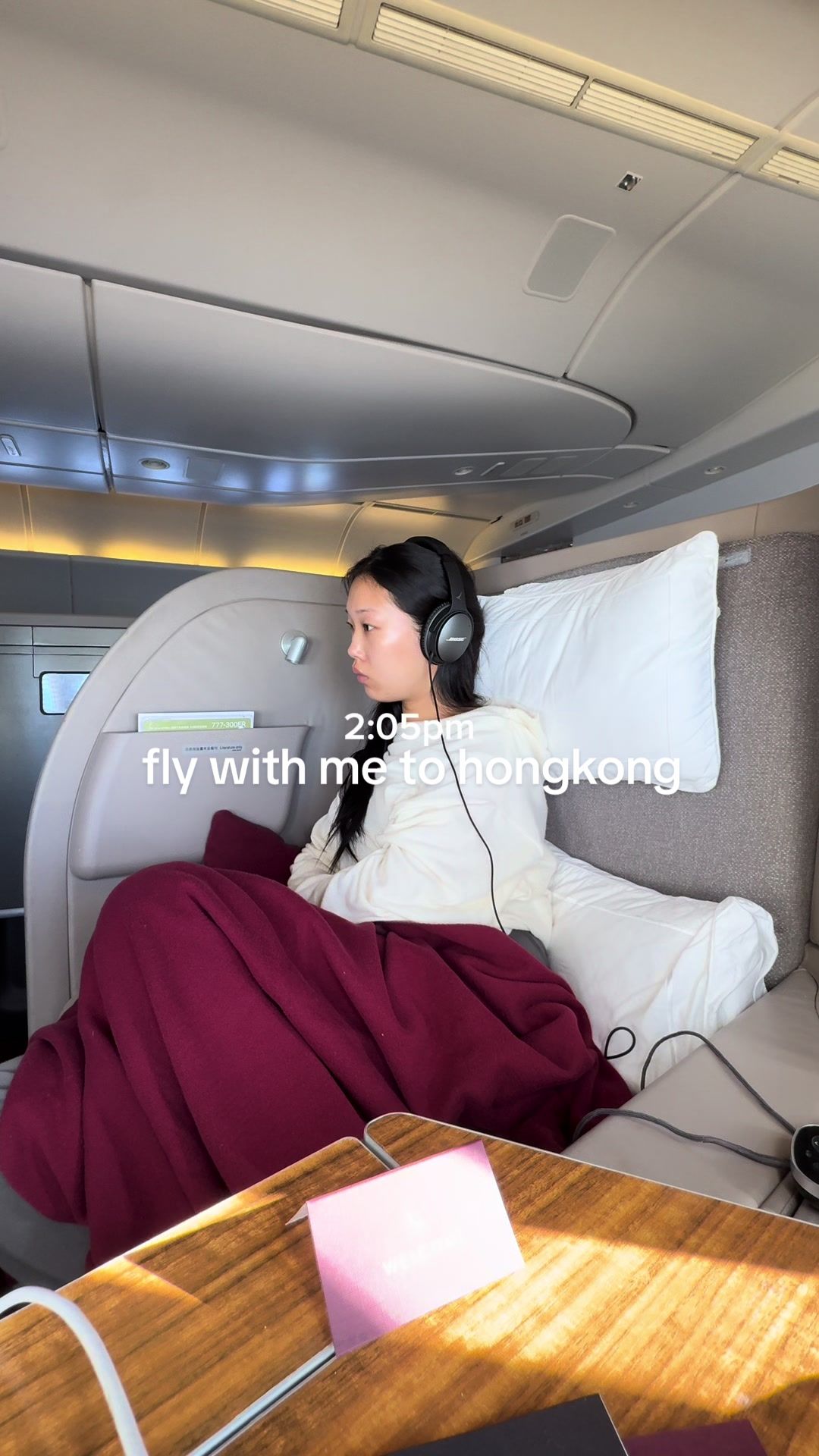 TikTok post by @via..li for Cathay Pacific. Caption reads: fly with me to hongkong! (first time flying....