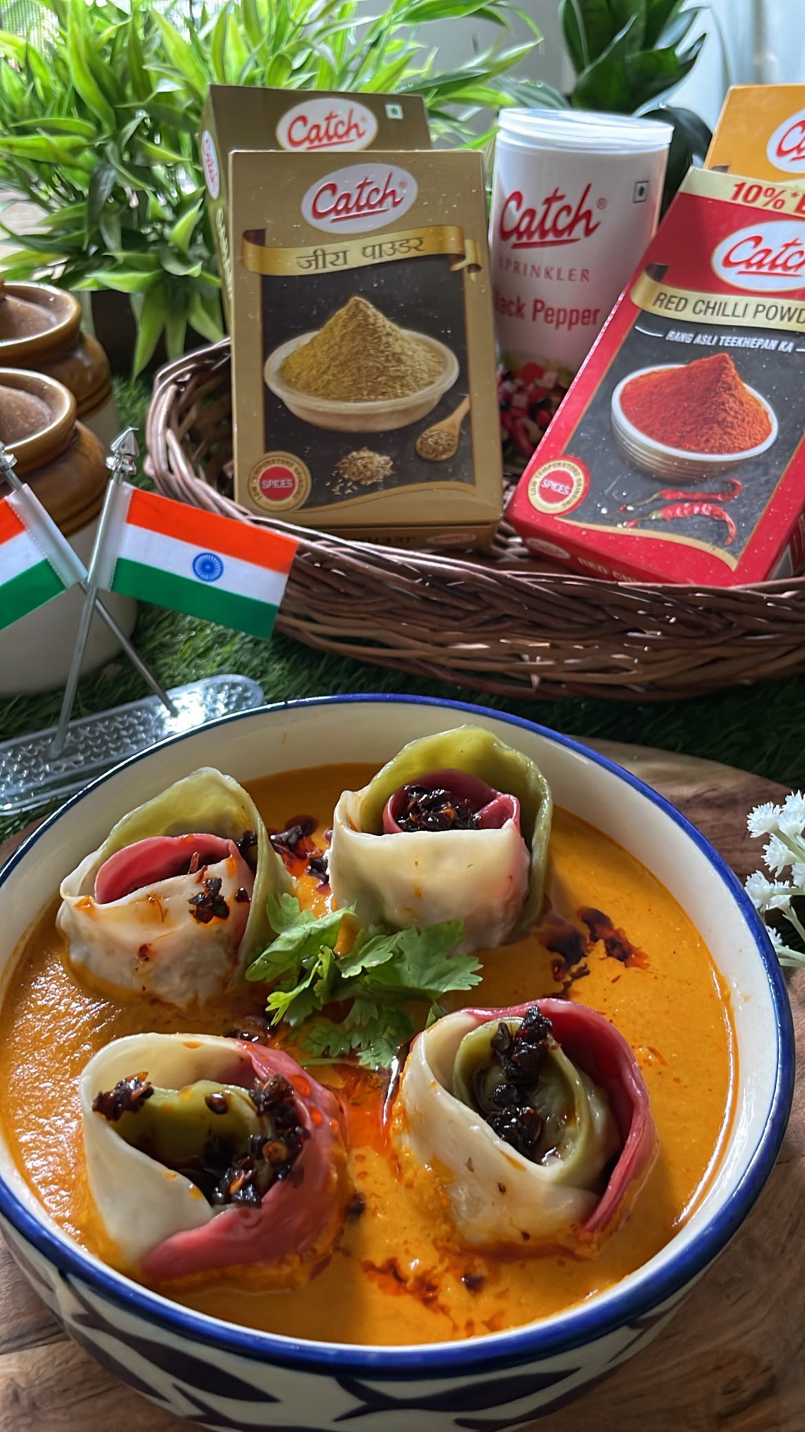 Instagram post by @lucknow_cuisine for Catch Foods. Caption reads: Steamy Jhol Momos 🥟✨ with a rich paneer &....