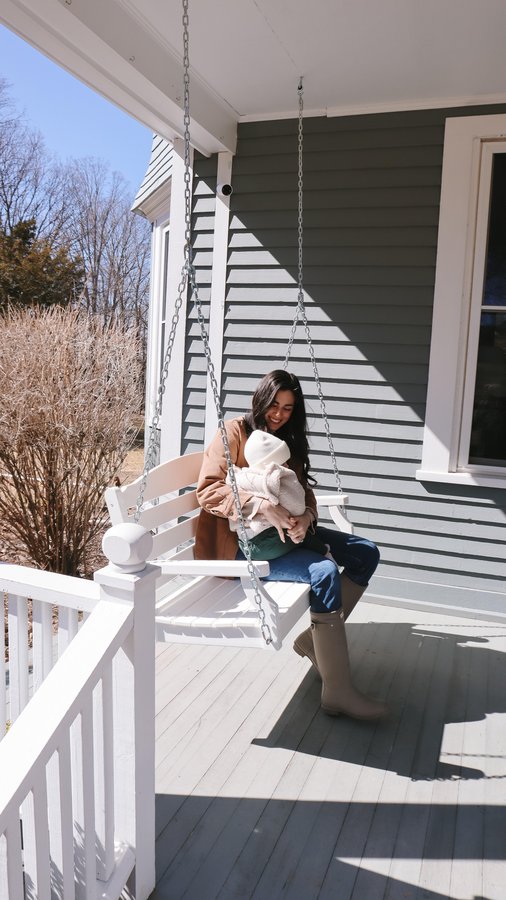 Instagram post by @byhilaryrose for Draper James. Caption reads: Our front porch was just begging for a swing 🤍 We....