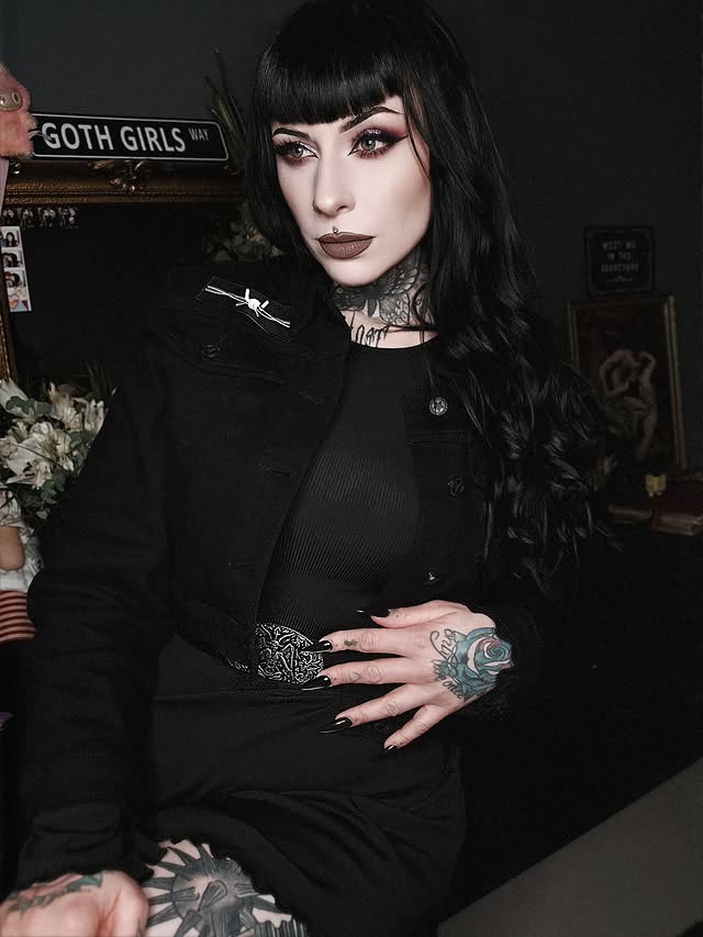 Instagram post by @debbythestrange_ for Blackcraft Cult. Caption reads: [...] 𝔏𝔬𝔯𝔡⛓️🗡 . Belt + Denim jacket....