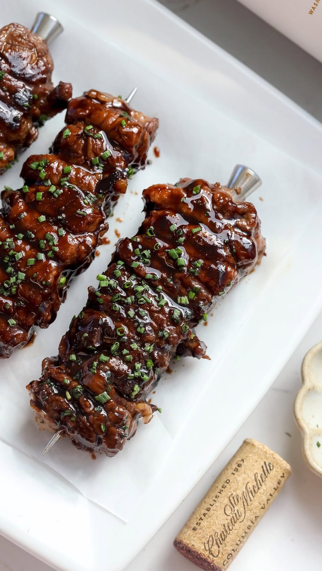 Instagram post by @foodmymuse for Chateau Ste. Michelle Winery. Caption reads: #ad Balsamic & Wine Glazed Ribeye Skewers + a nice....