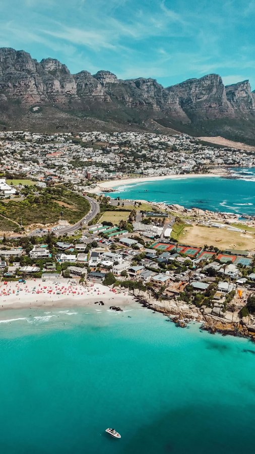 Instagram post by @campsbaygirl for Corona. Caption reads: Share with someone that needs to go here! 🌅 I am....