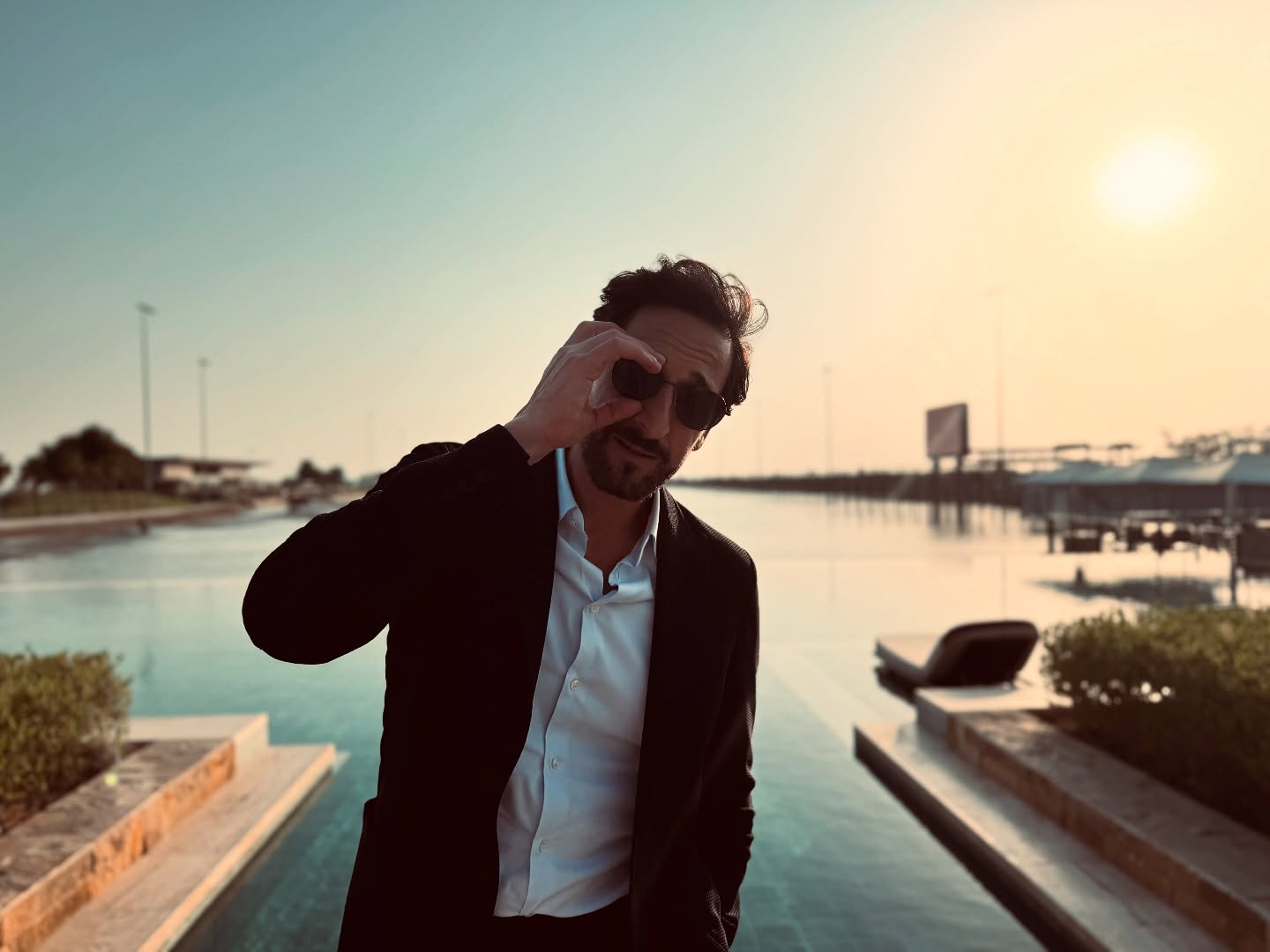 Instagram post by @adrienbrody for Visit Abudhabi. Caption reads: Thank you, Abu Dhabi, for the magical adventure....