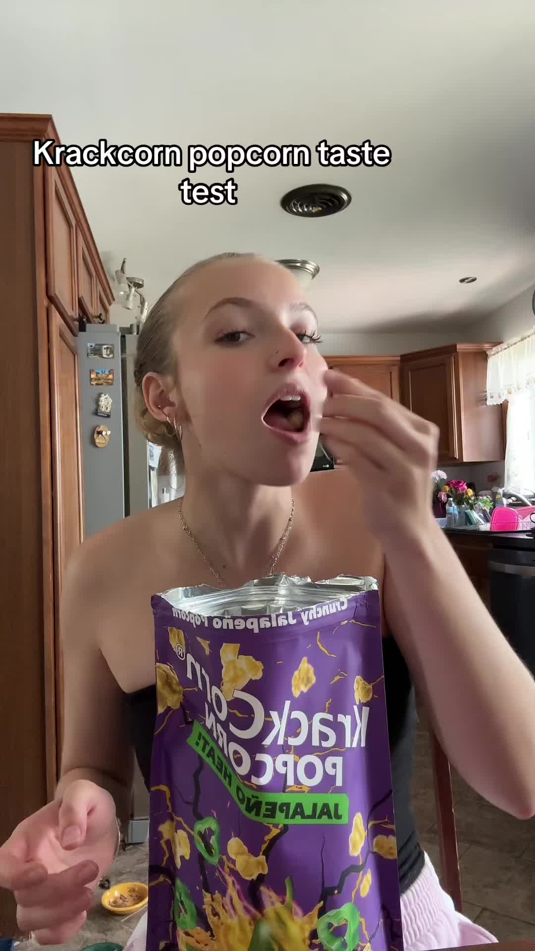 TikTok post by @reina_unger for KrackCorn Popcorn. Caption reads: @KrackCorn Popcorn just supporting a small family....