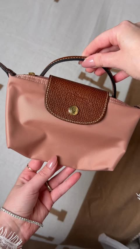 Instagram post by @itsjessicalinn for Longchamp. Caption reads: Unboxing a new Longchamp mini pouch in the color....