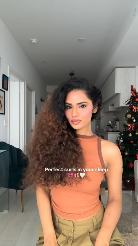 Instagram post by @nisha_kmr for Moroccanoil. Caption reads: Low effort and very highly complimented Hair curls....