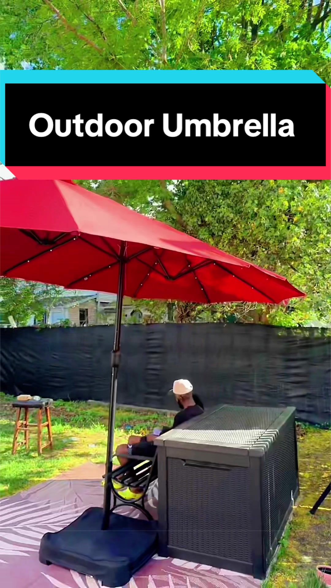 TikTok post by @quettenic for Phi Villa. Caption reads: [...] #patioumbrellawithlights @PhiVillaUS.