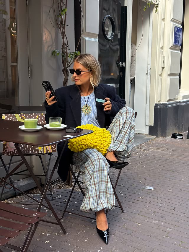 Instagram post by @oliviatps for Never Fully Dressed. Caption reads: [...] happened to be Amsterdam with the....