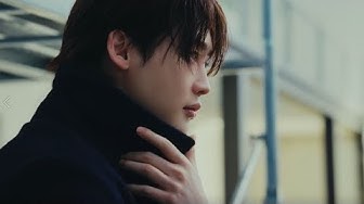 YouTube post by @ARENAKOREATV for DKNY. Caption reads: #제작지원 DKNY를 입은 이종석의 발걸음을 따라 그가 선 도시로 향했습니다. 분주한....