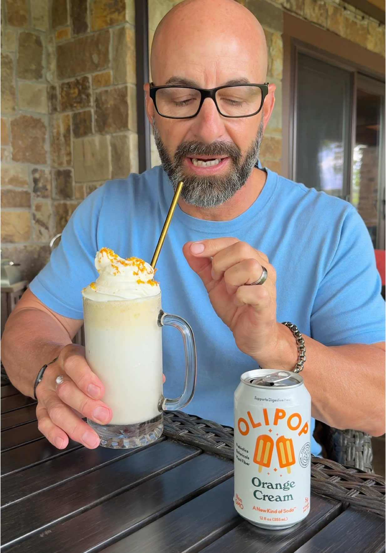 TikTok post by @johnrondi for OLIPOP. Caption reads: [...] Orange Creamsicle Float 🍊 @OLIPOP....