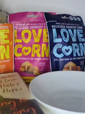 TikTok post by @sz_journal for LOVE CORN. Caption reads: In the world of boring snacks, grab Love corn that....