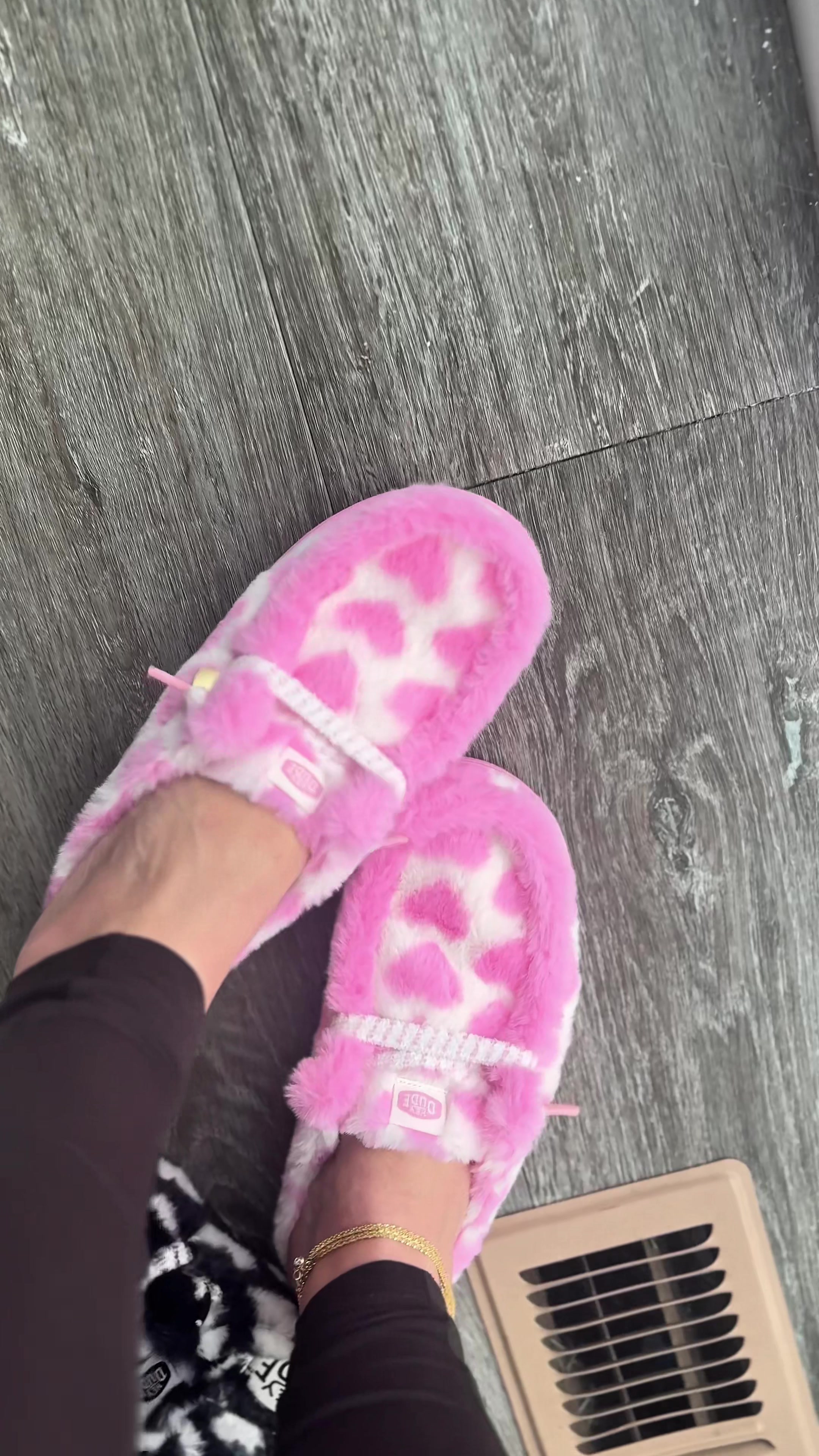 TikTok post by @thekrystalpearl for HEYDUDE shoes. Caption reads: @HeyDude just dropped a pink fuzzy heart slipper....