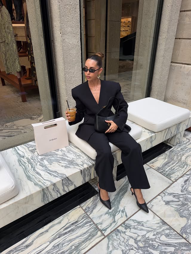 Instagram post by @melinabudek for REVOLVE. Caption reads: coolest coffee @ysl 🐅☕️ fit @revolve @shopeaves....