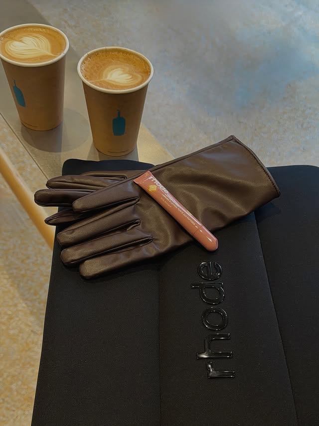 Instagram post by @im._.soniamahmoudieh for Rhode Skin. Caption reads: today’s essentials: confidence, caffeine, and....