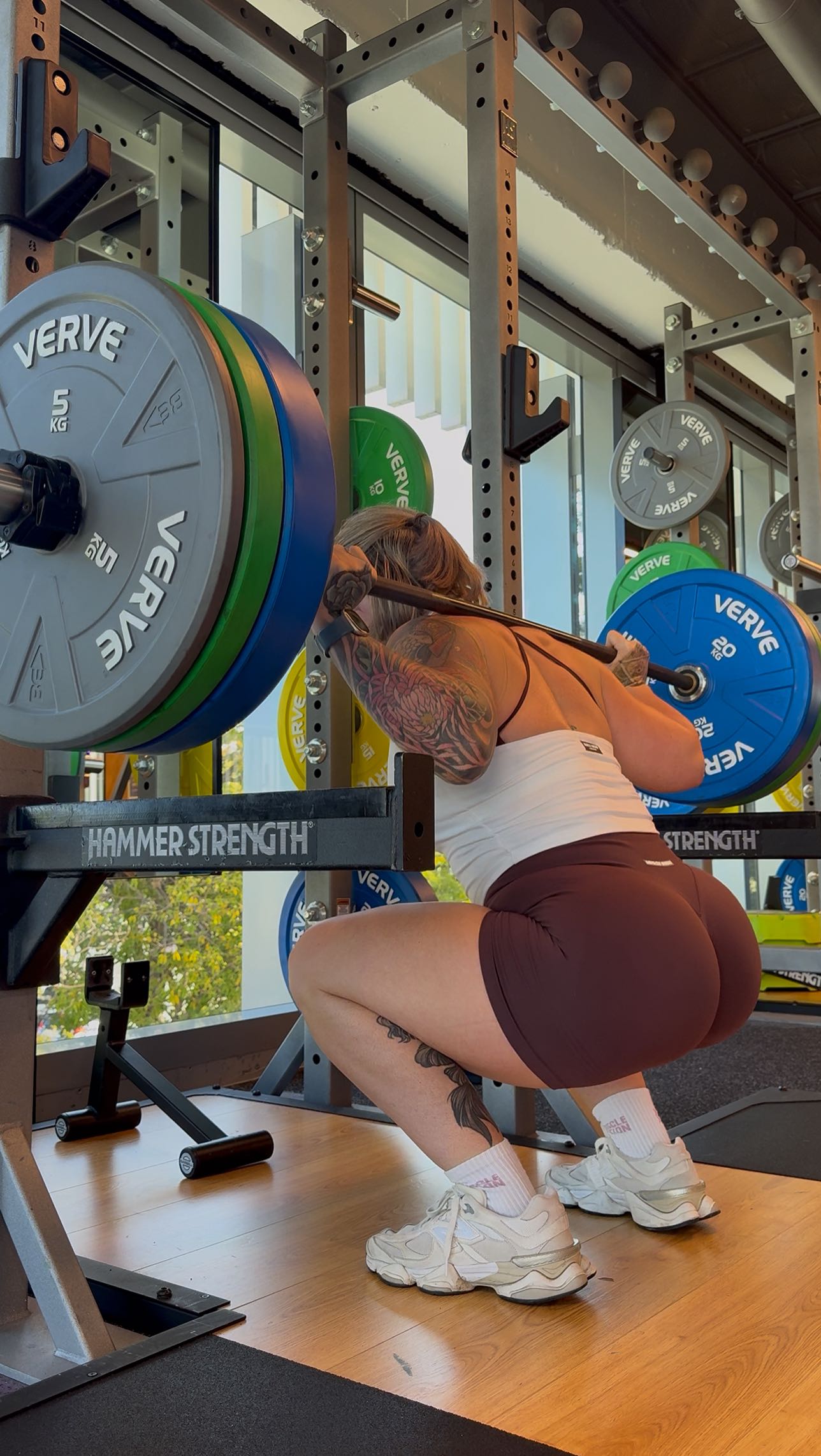 Instagram post by @_elliewilsonfitness__ for Muscle Nation. Caption reads: 😭 in a love/hate relationship with leg day.....