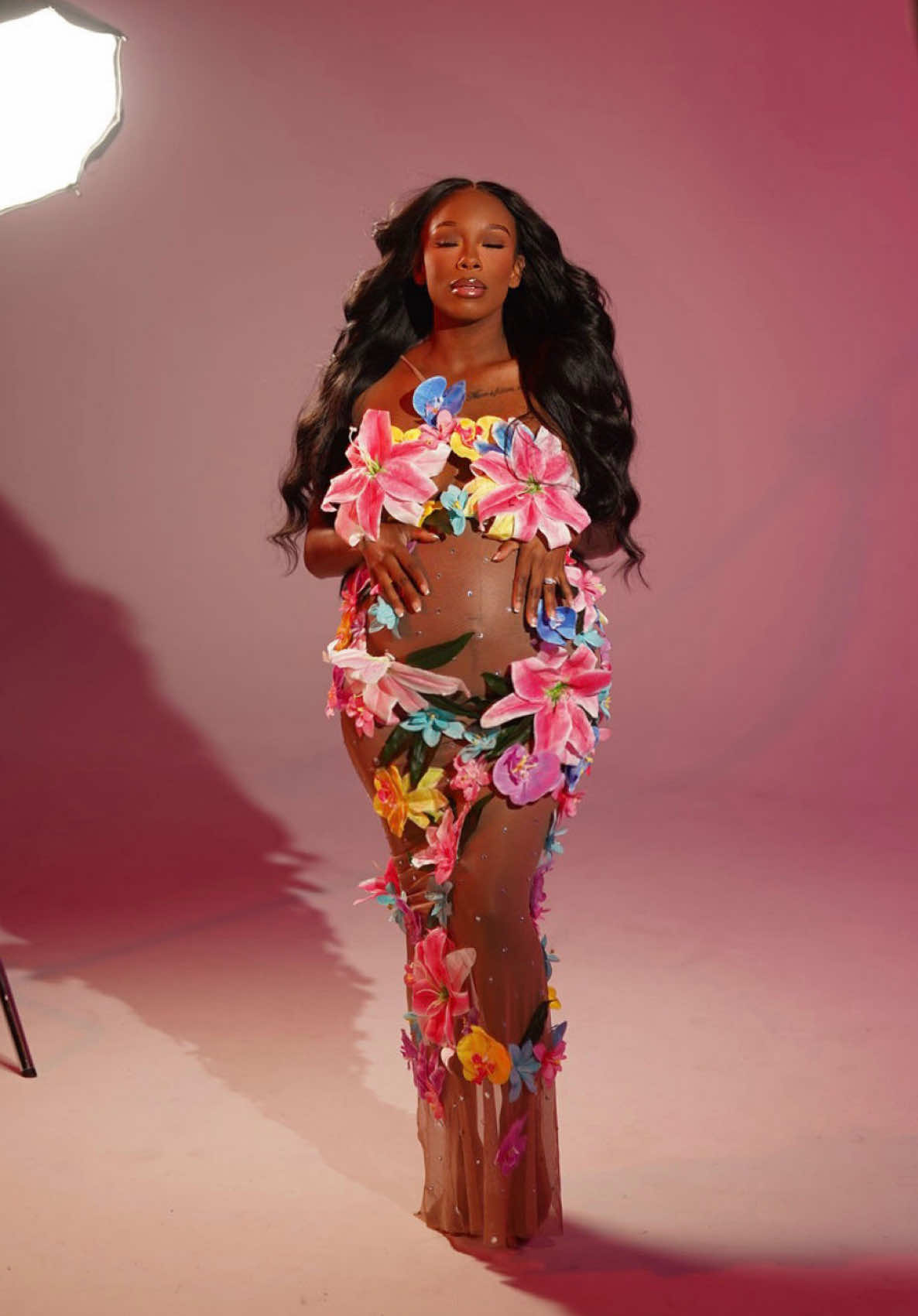 TikTok post by @chanelatbest for Mew Mews. Caption reads: [...] a family, stay tuned. 🤰🏽🙏🏾 Dress: @Mew....