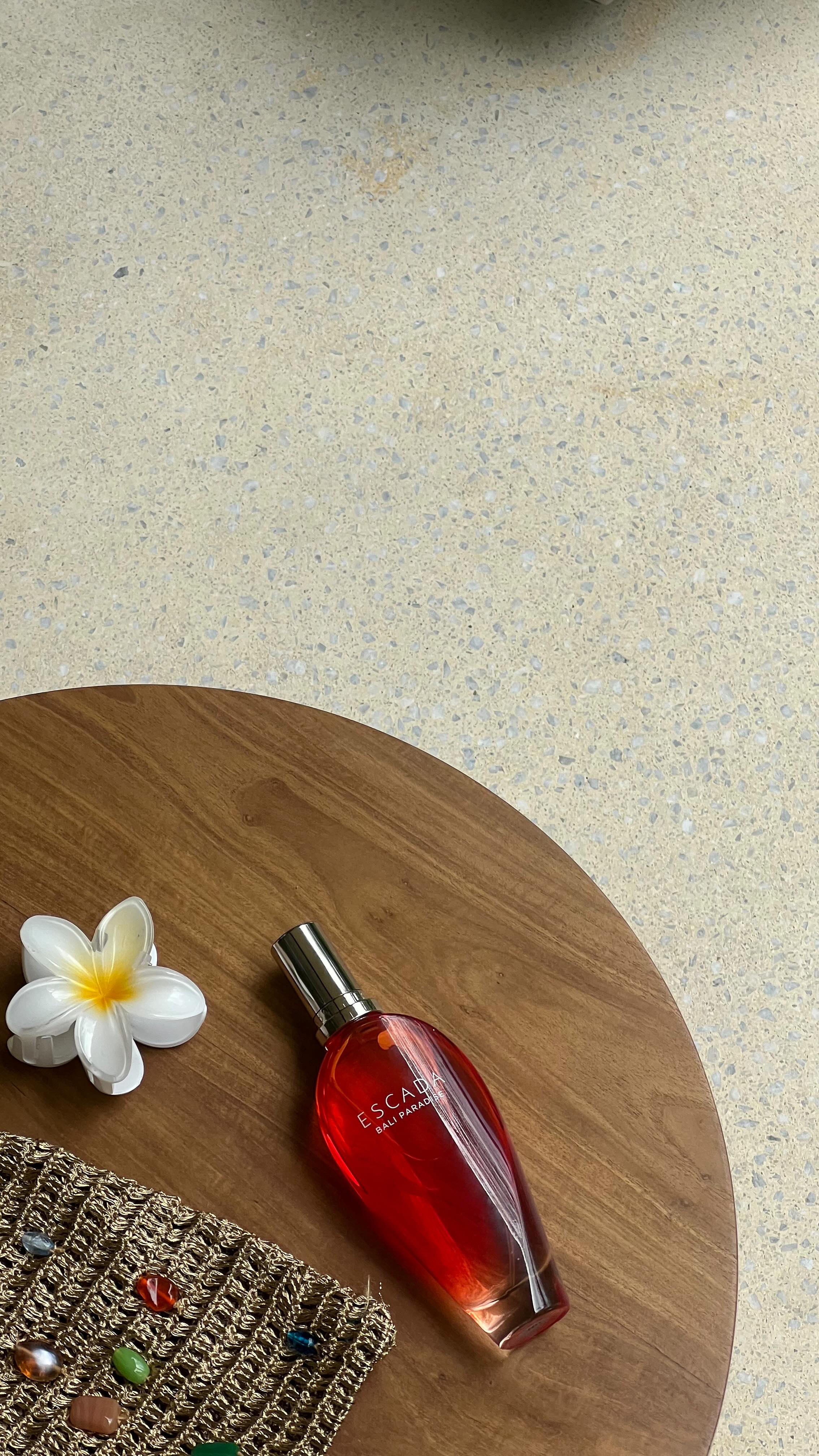 Instagram post by @aina.simon for Escada Fragrances. Caption reads: [...] like confidence🌟 #baliparadise....