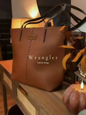 TikTok post by @katiegraff2 for Vaqueras Outfitters. Caption reads: 🤎🤎 @Vaqueras Outfitters #purse #shoulderbag....