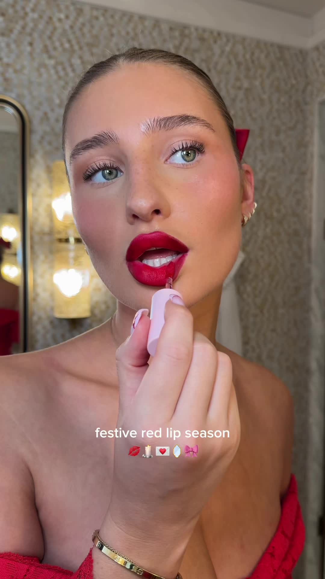TikTok post by @charbarker for Glossier. Caption reads: [...] festive red lip season 💋💄 wearing....