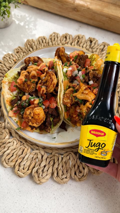 Instagram post by @cooking_con_claudia for MAGGI Belgium. Caption reads: #MaggiPartner These surf & turf tacos hit every....