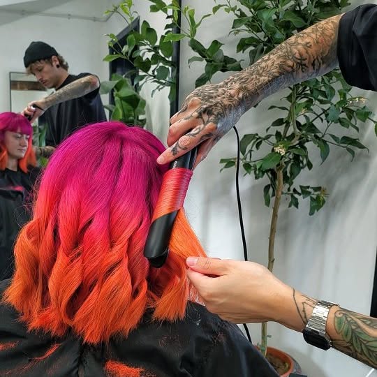 Instagram post by @jaymz.marsters for Biolage. Caption reads: Neon pink & orange transformation 🤙

Posted the....