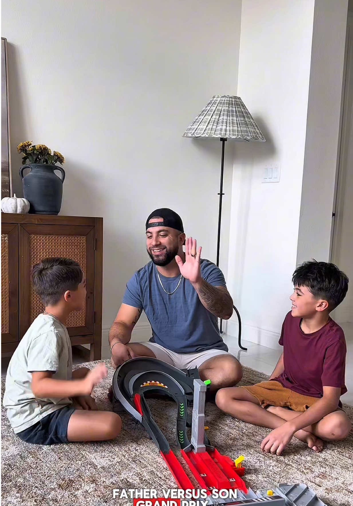 TikTok post by @thechavezfamilyy for Hot Wheels. Caption reads: Family race day at home 🏎️ The new @Hot Wheels....