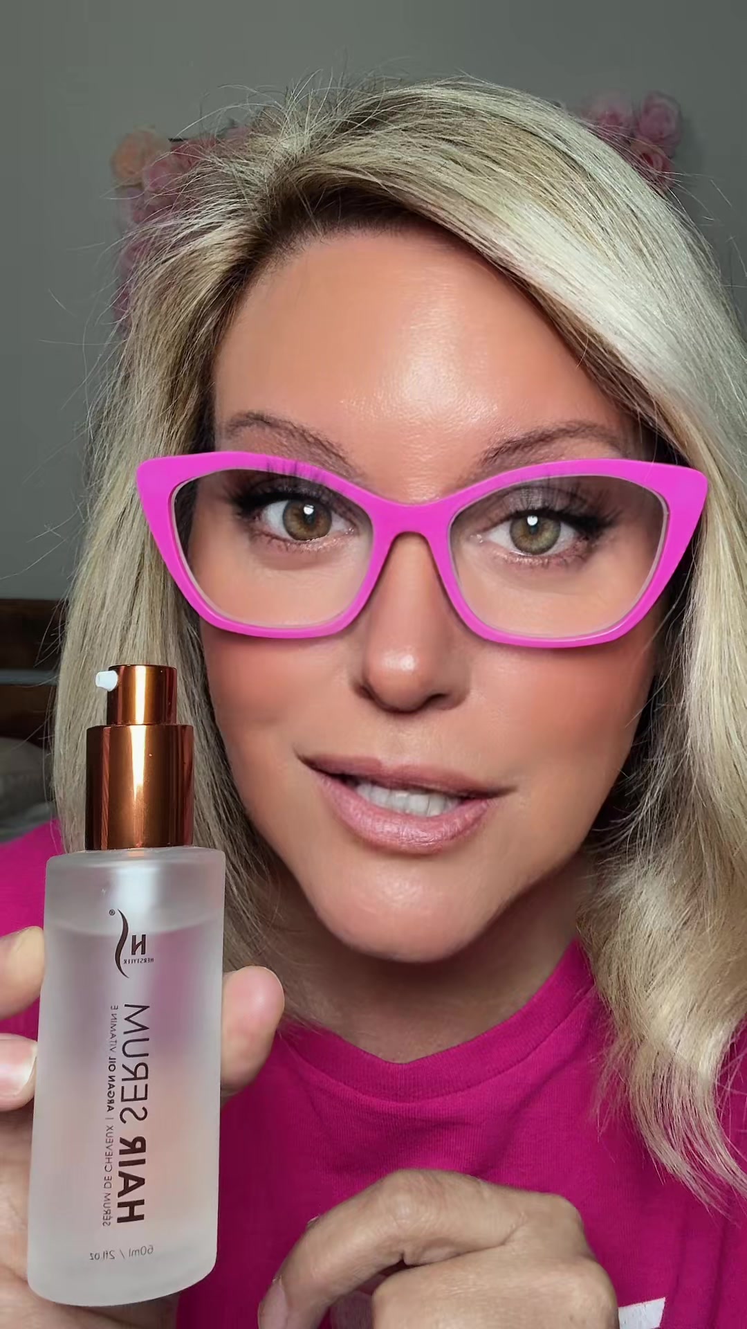 TikTok post by @stephaniebama2025 for HerStyler Haircare. Caption reads: Let’s tame that frizz #hairtok #hairserum....