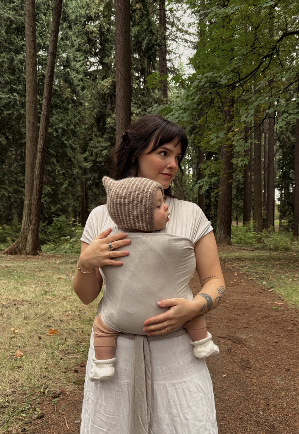 TikTok post by @oui..emma for Solly Baby. Caption reads: [...] against mine🤎 i love love using my @Solly....