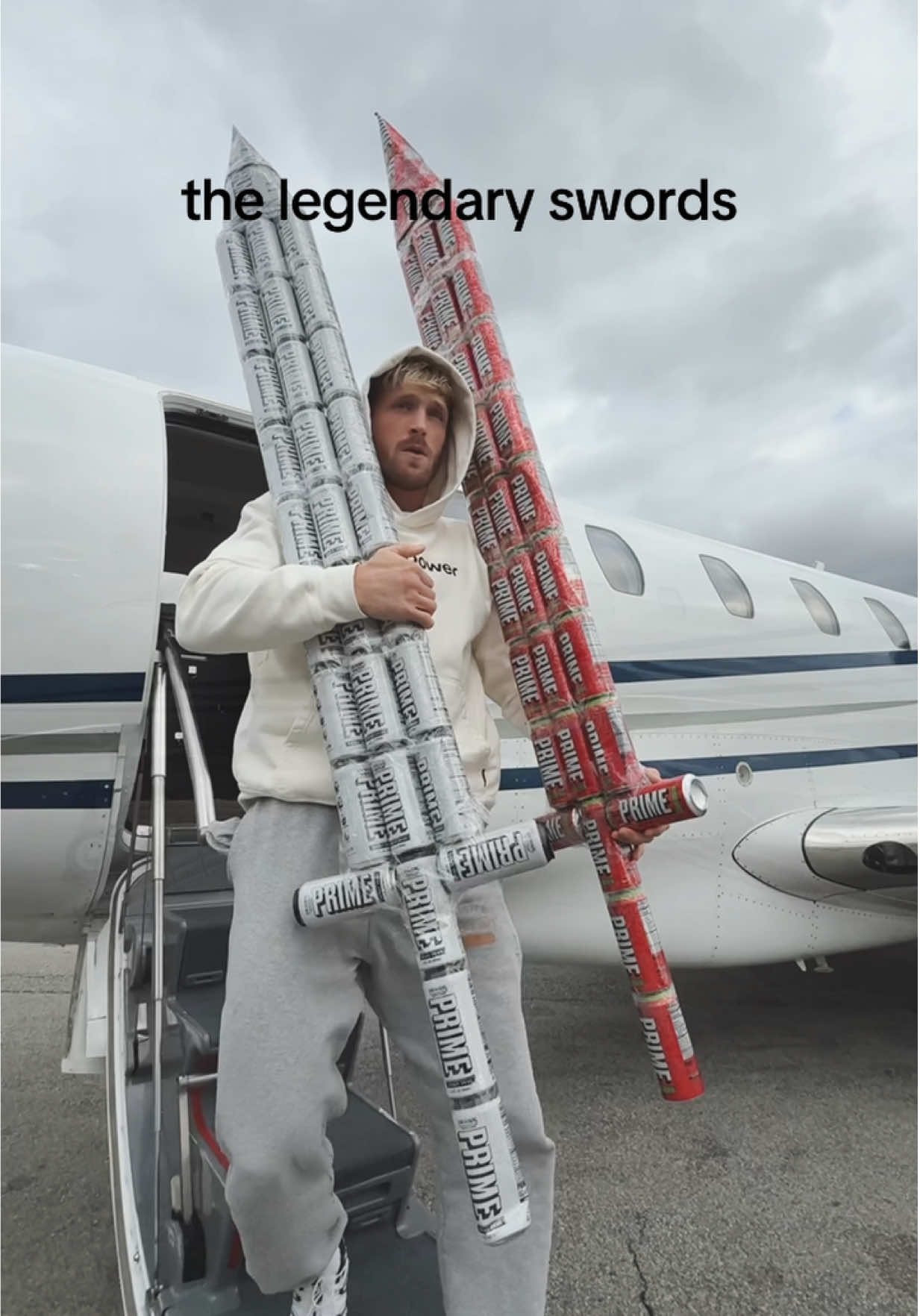 TikTok post by @loganpaul for DrinkPrime. Caption reads: dual wielding @PRIME energy (18+) #primepartner .