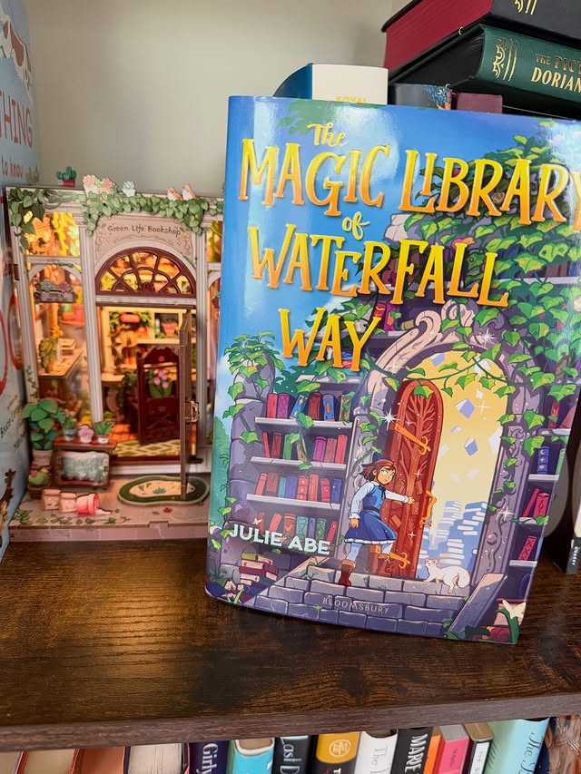 Instagram post by @booksandlagniappe for Bloomsbury Publishing. Caption reads: ✨Book Spotlight ✨ The Magical Library of Waterfall....