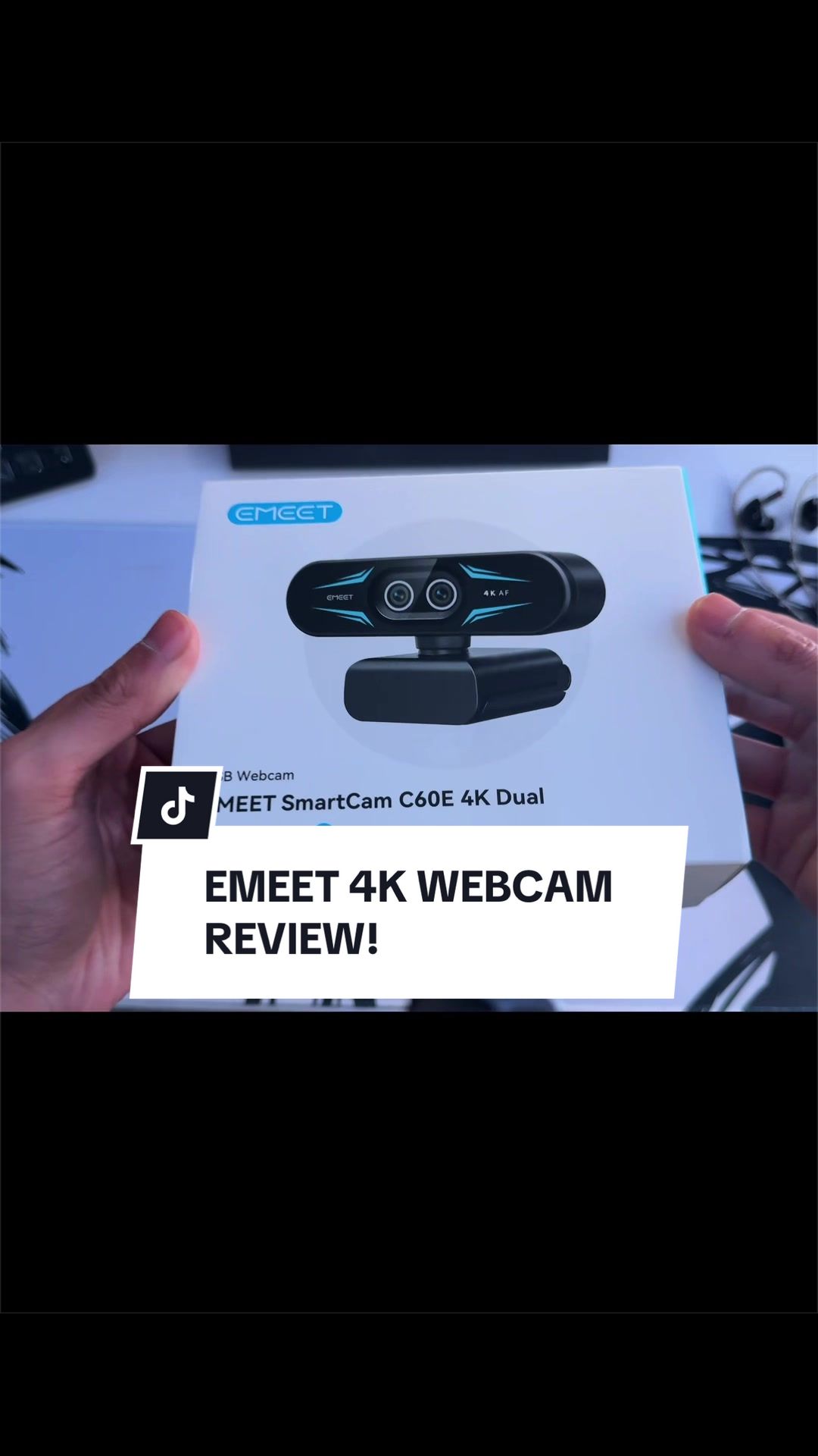 TikTok post by @tron1xtech for EMEET. Caption reads: EMEET C60E 4K Webcam Unboxing + Review! By far....