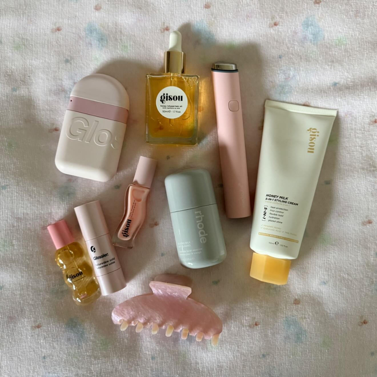 Instagram post by @carrieanne_ for Glossier. Caption reads: Sunday mood 🎀🍯🪽

@gisou* @rhode* @glossier*....