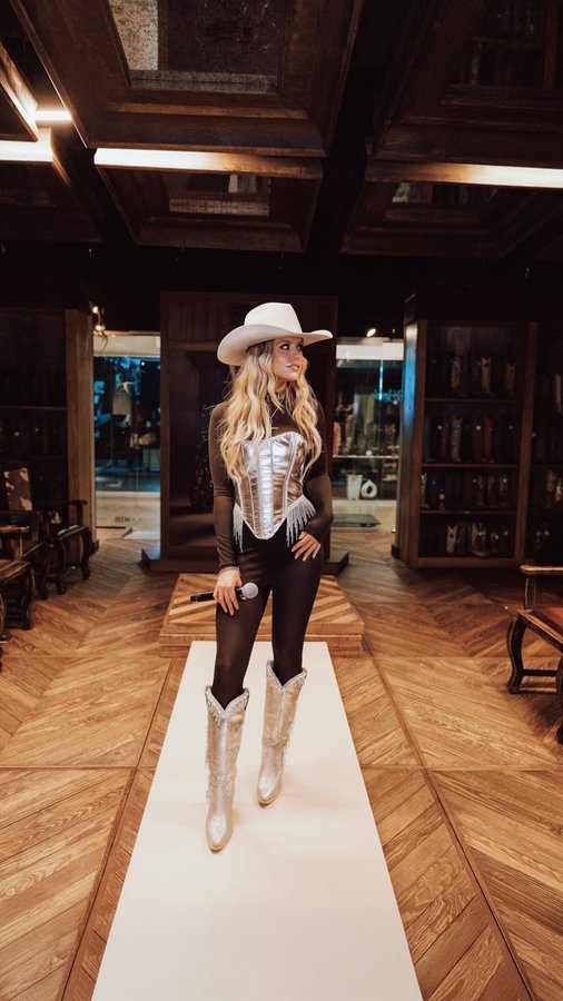 Instagram post by @ashleywalls_ for Corral Boots. Caption reads: [...] 🎶 Stay tuned for what’s coming!....