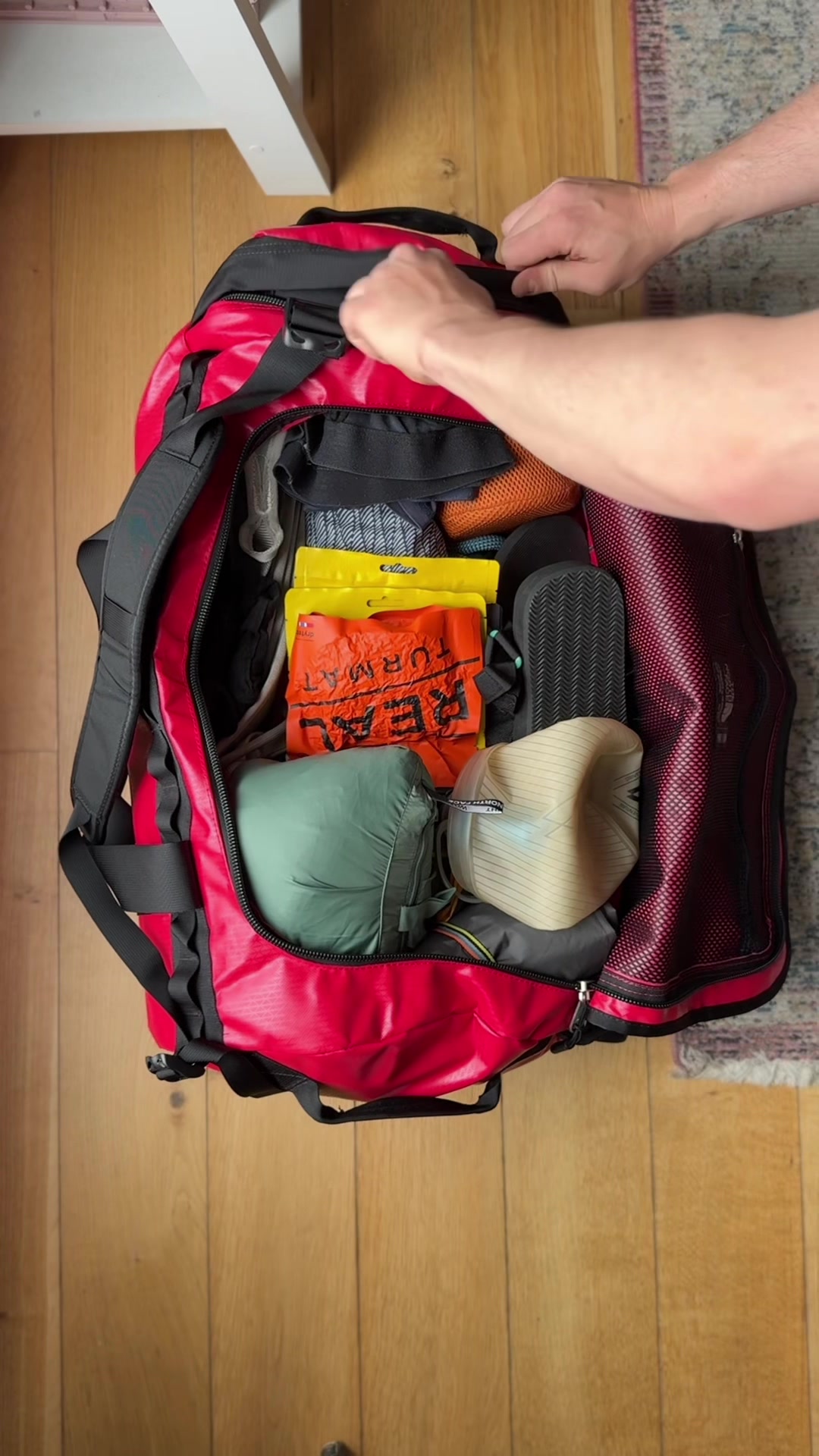 TikTok post by @leavingtracks for thenorthface. Caption reads: Here’s how I pack my hold luggage for an....
