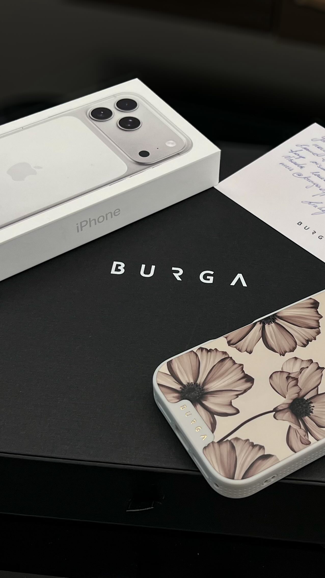 Instagram post by @gintarefiseriene for BURGA. Caption reads: 🍁✨ New season, new phone, same obsession — BURGA.....