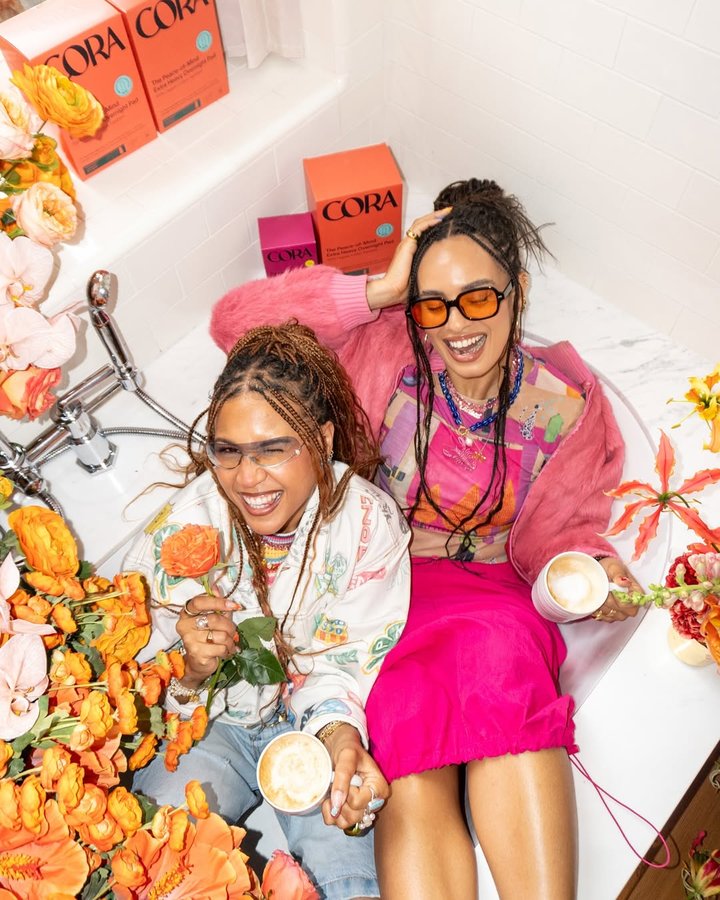 Instagram post by @byaimeekelly for Cora. Caption reads: [...] besties if you’re not synced? 🤞🏽 The Cora....