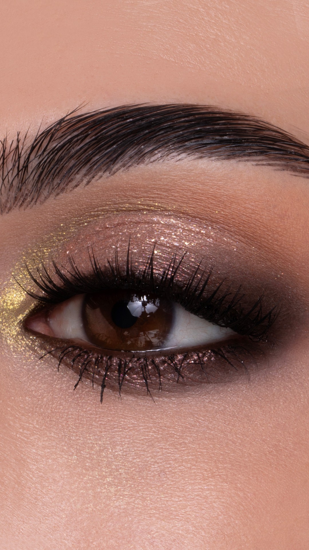 Instagram post by @nicoleblessy for M·A·C Cosmetics. Caption reads: Smoky. Shimmery. Golden ✨. We can't stop staring....