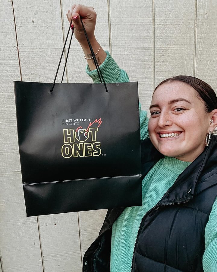 Instagram post by @ana.eats.pgh for First We Feast. Caption reads: HOT ONES DELIVERY 🔥🐔✨ I dunno about you, but Hot....