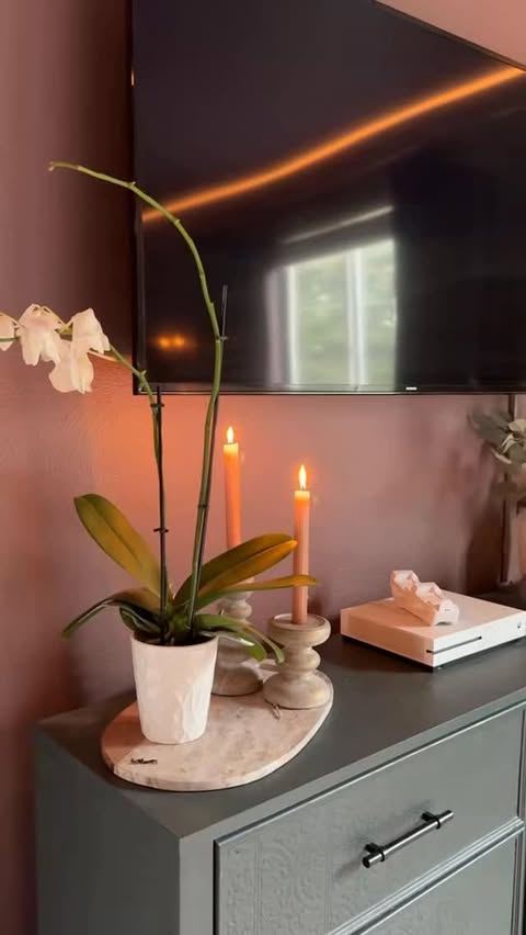 Instagram post by @gatheratthebooths for Benjamin Moore. Caption reads: Tell me why dark + moody bedrooms feel instantly....